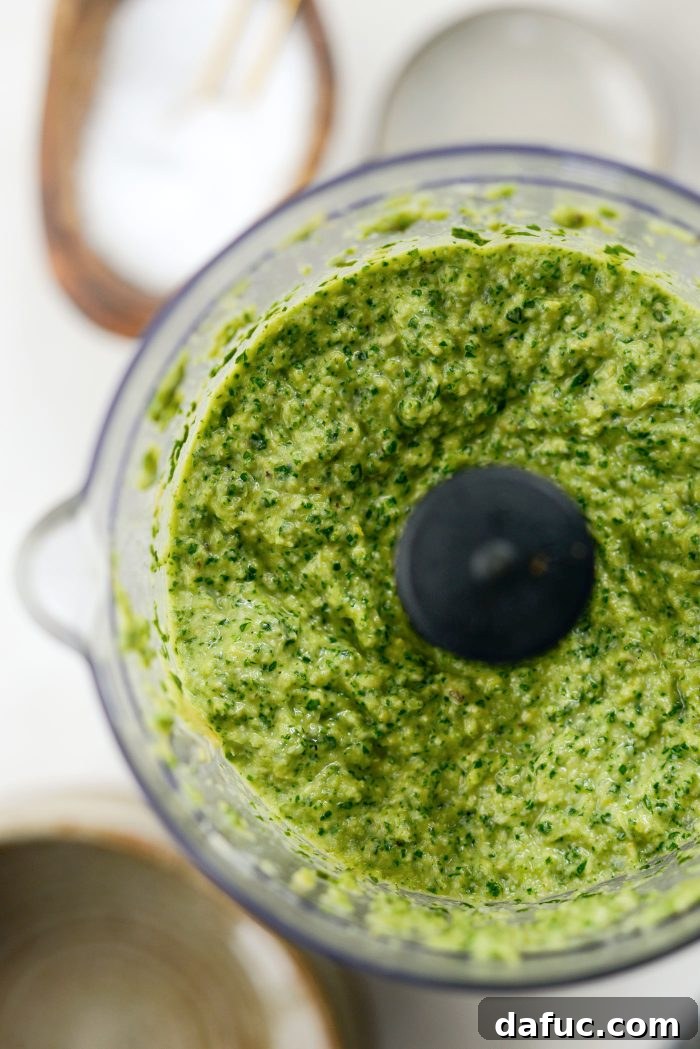Creamy Artichoke Arugula Dip 10 The food processor blending the dip until smooth and creamy.