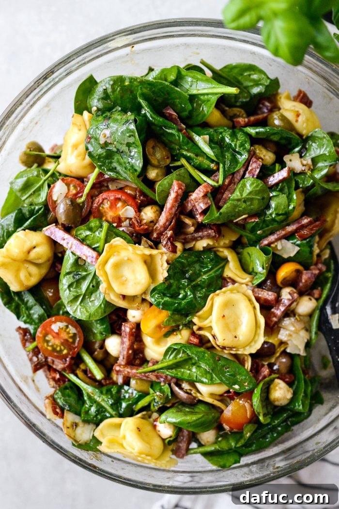 Rustic Tuscan Tortellini Salad 13 Tossing the Tuscan Tortellini Pasta Salad to combine ingredients