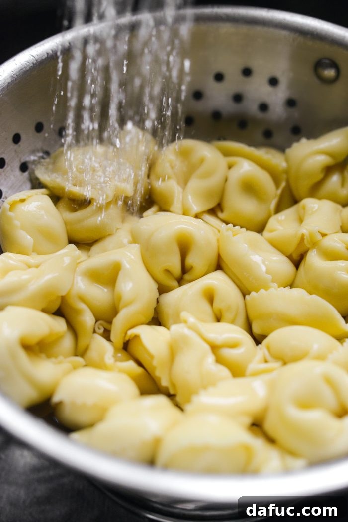 Rustic Tuscan Tortellini Salad 9 Rinsing cooked tortellini under cold water