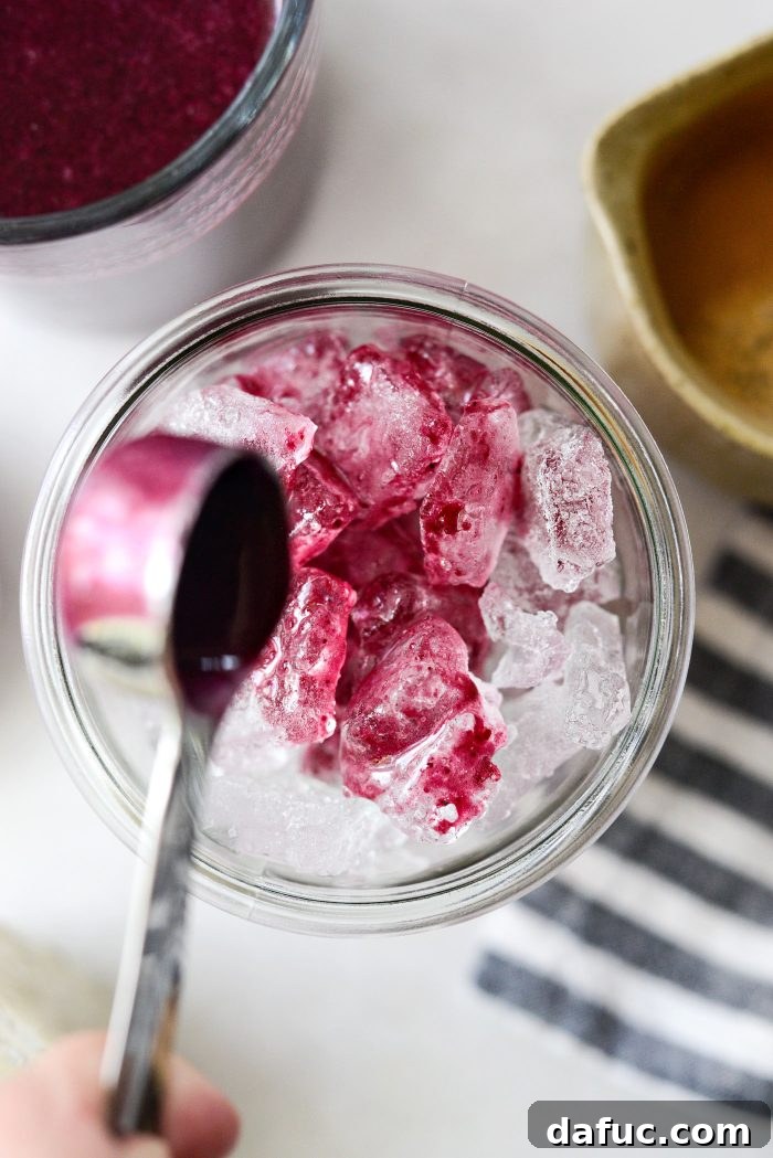 Adding blueberry syrup to ice