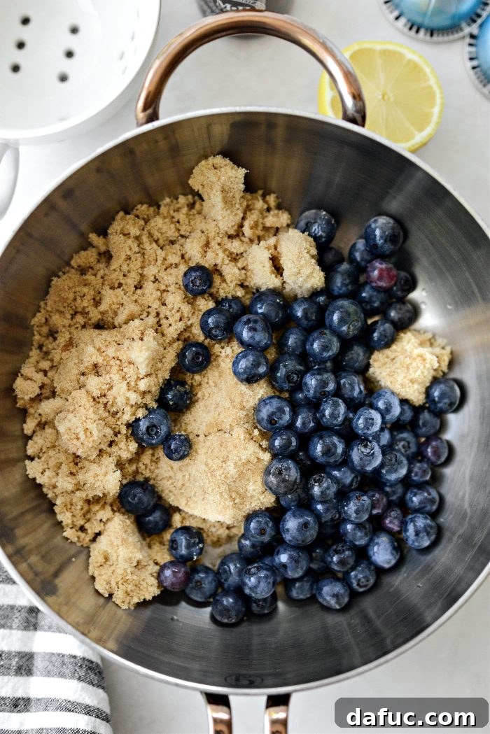 Brown sugar and blueberries in a saucepan for syrup