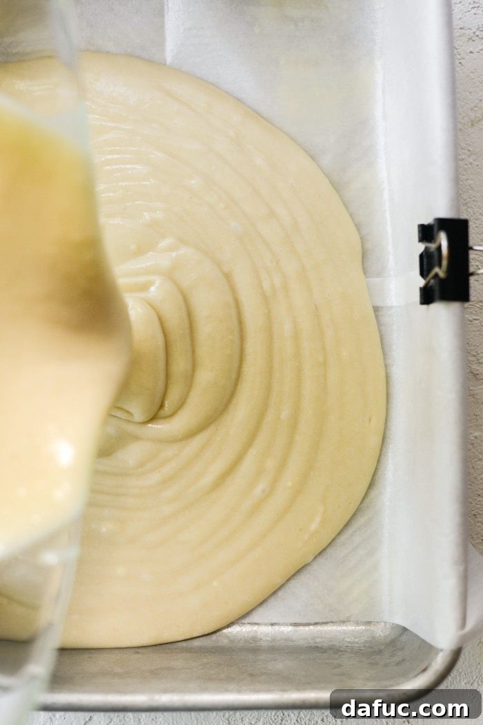Pouring cake batter into the prepared pan