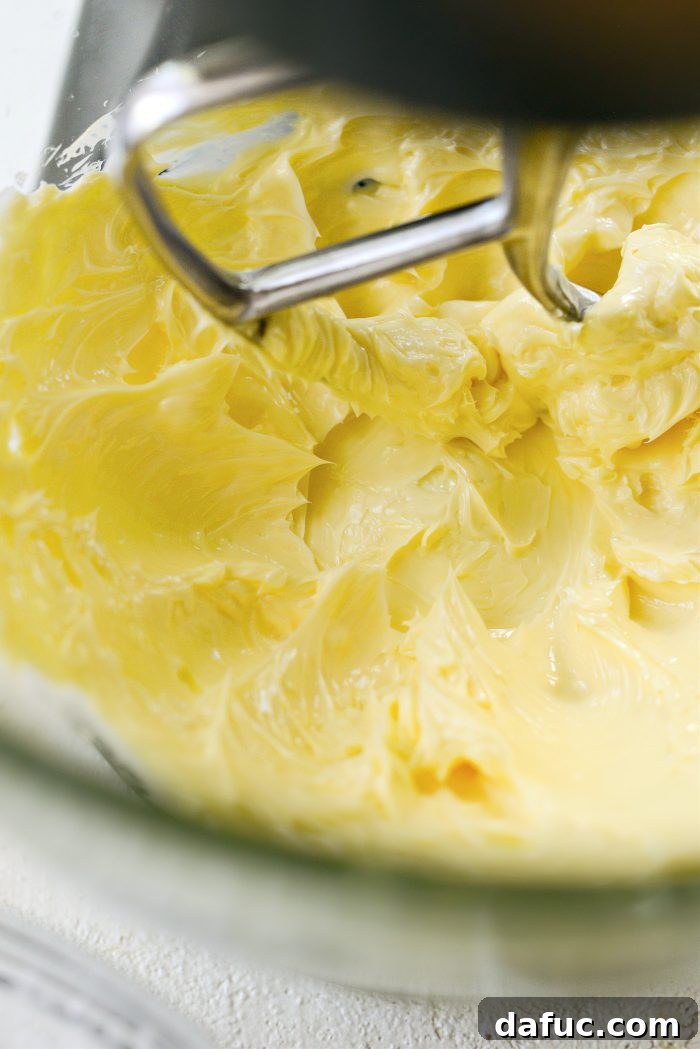 Creaming softened butter in a stand mixer until light and fluffy.