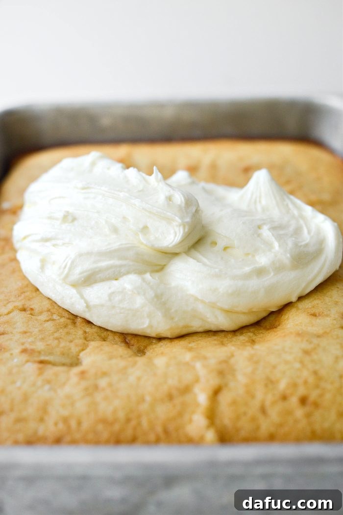 Spreading two-thirds of buttercream on the cooled cake