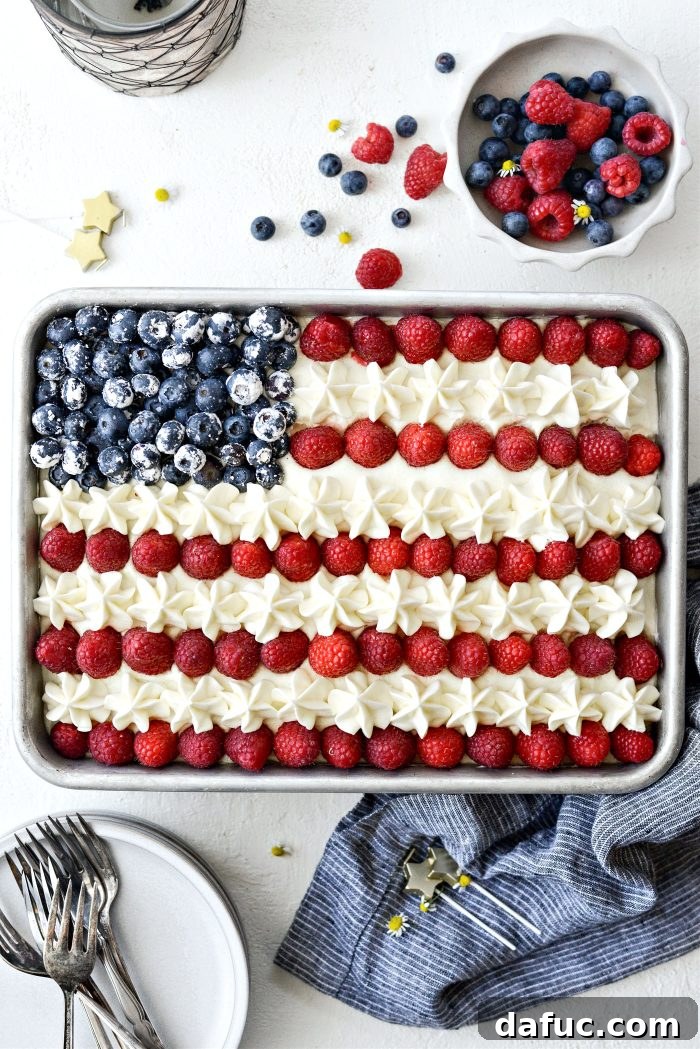Arranging blueberries and raspberries to create an American Flag design