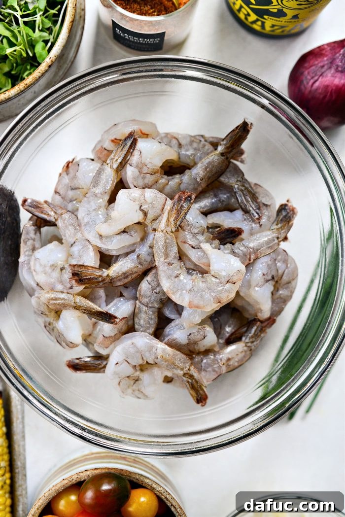 Spiced Blackened Shrimp Summer Salad with Sweet Corn and Feta 8 Two pounds of peeled and deveined raw shrimp in a bowl