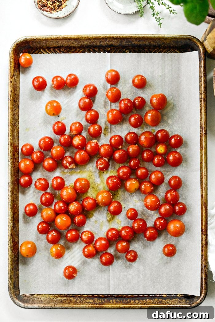 Sweet Blistered Tomatoes, Creamy Burrata, Crispy Pancetta 13 Cherry tomatoes and fresh thyme sprigs added to a prepared baking sheet.