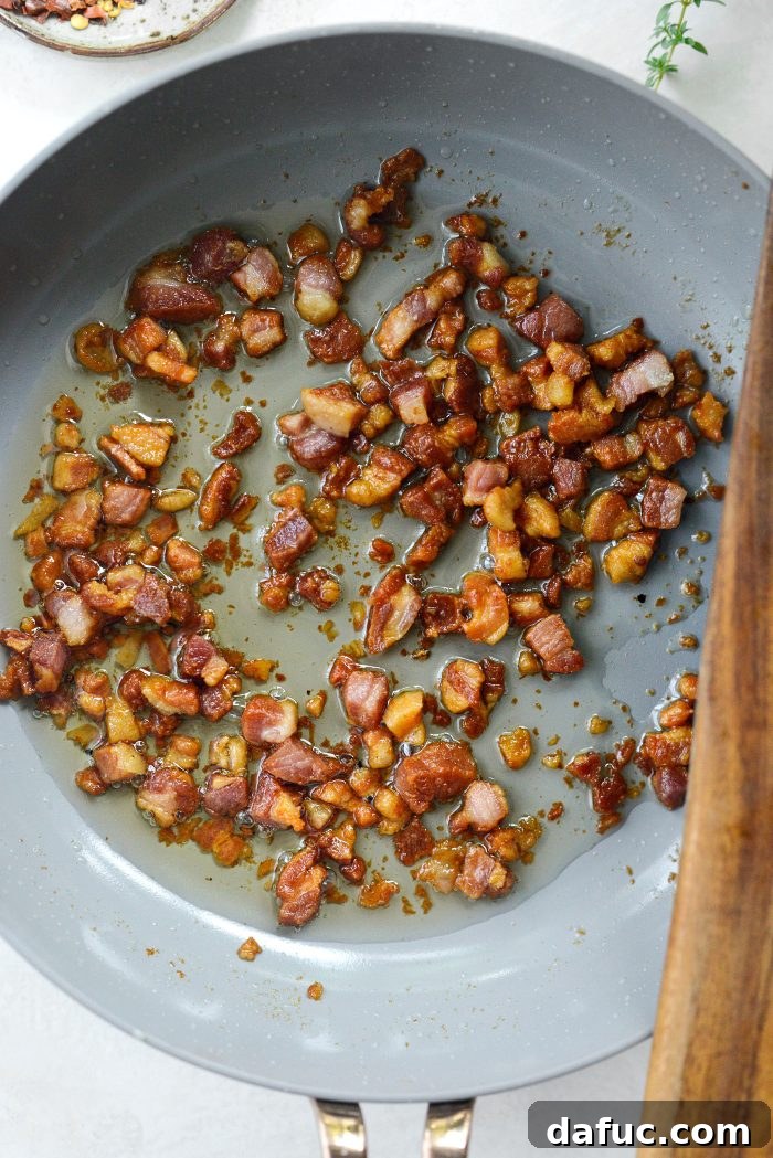Sweet Blistered Tomatoes, Creamy Burrata, Crispy Pancetta 9 Crispy fried pancetta in a skillet, ready to be removed.