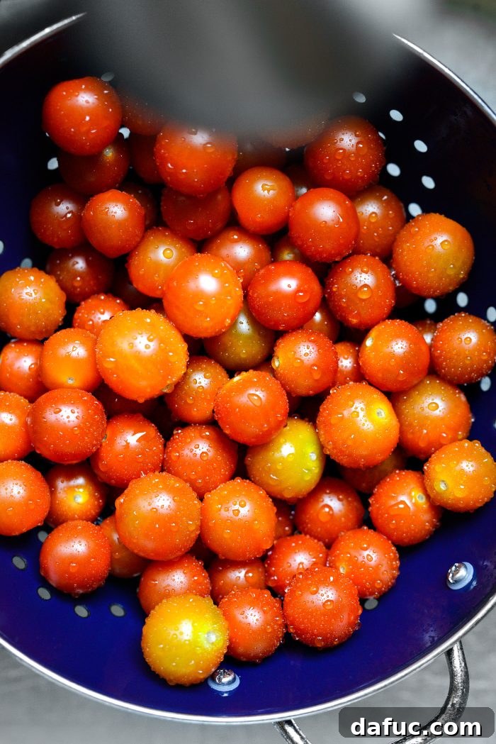Sweet Blistered Tomatoes, Creamy Burrata, Crispy Pancetta 10 Rinsing fresh cherry tomatoes under water.