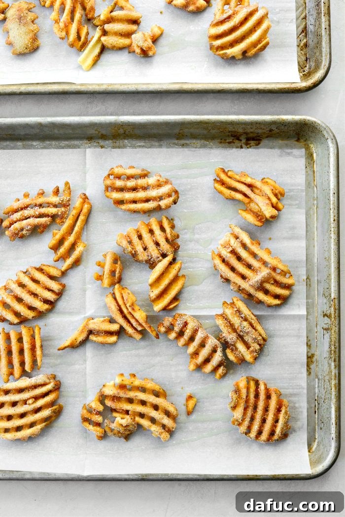 Ultimate Burger Bowl Creations 6 Frozen waffle fries arranged on a baking sheet