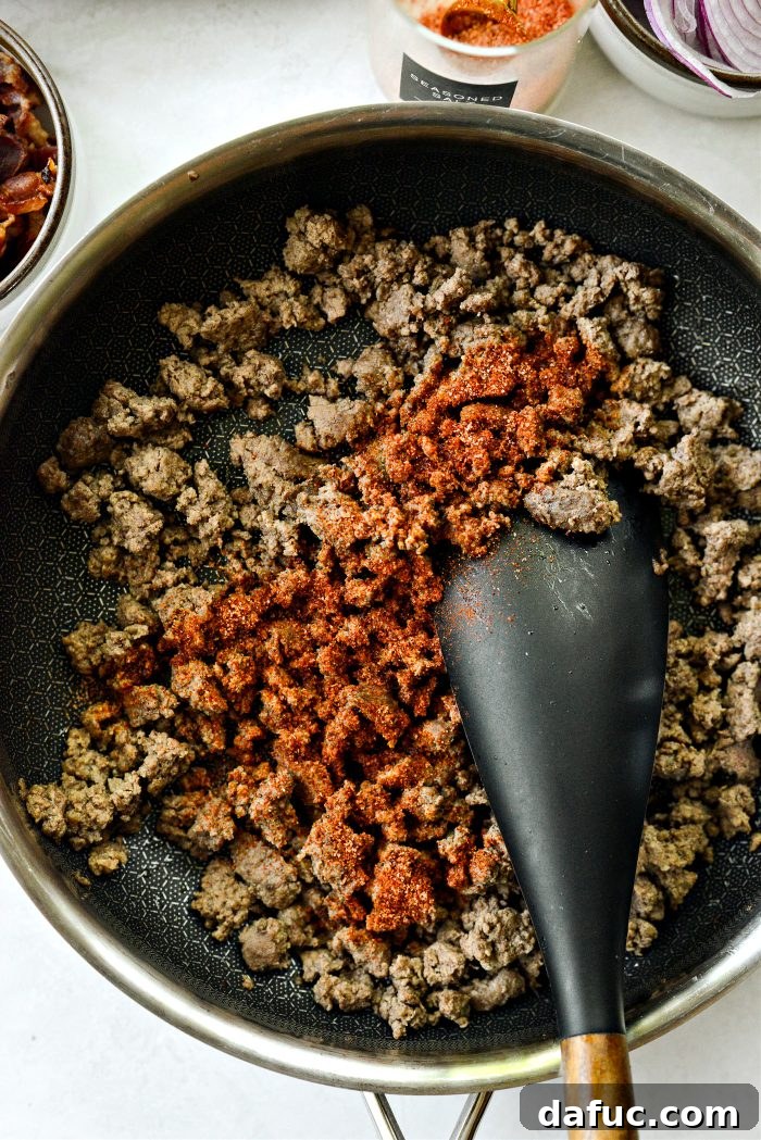 Ultimate Burger Bowl Creations 9 Seasoning ground beef in a skillet
