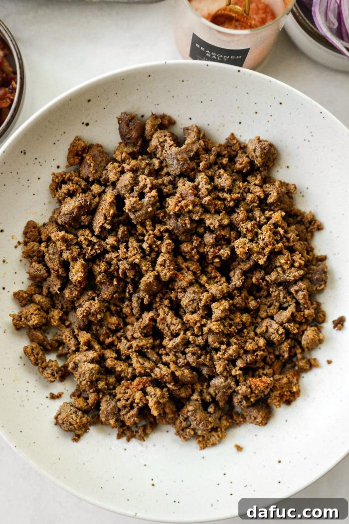 Ultimate Burger Bowl Creations 10 Seasoned ground beef cooling in a bowl