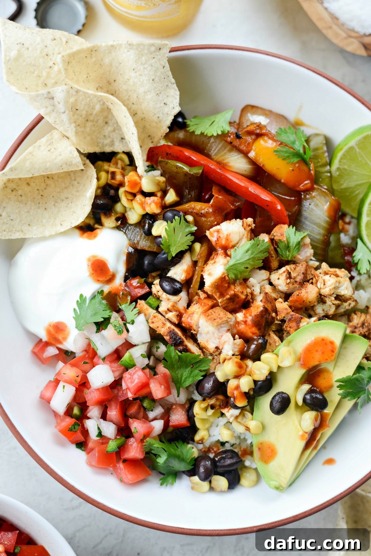 Smoky Chipotle Chicken Fajita Bowl 14 Hands arranging ingredients into a Chipotle Chicken Fajita Rice Bowl