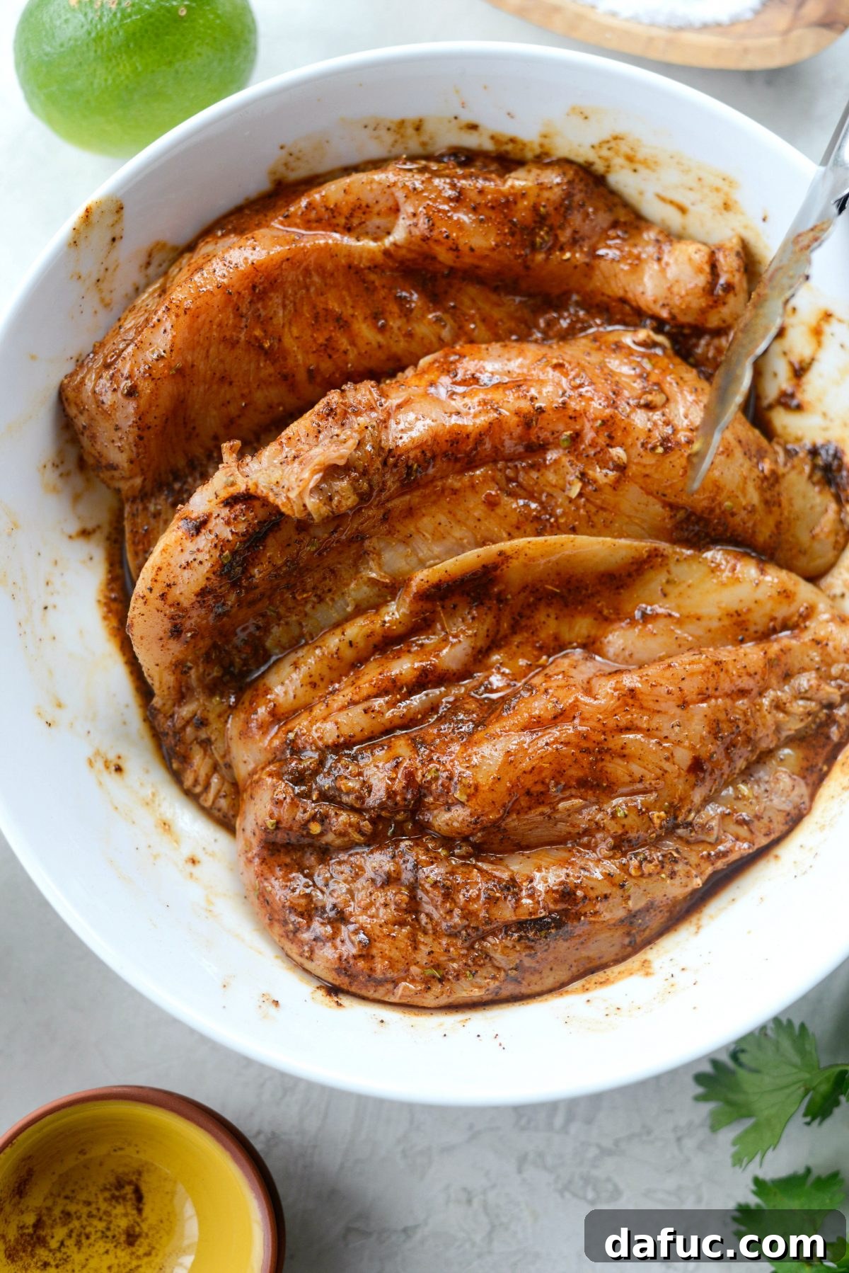 Smoky Chipotle Chicken Fajita Bowl 7 Close-up of marinated chicken in a bowl, ready to be cooked