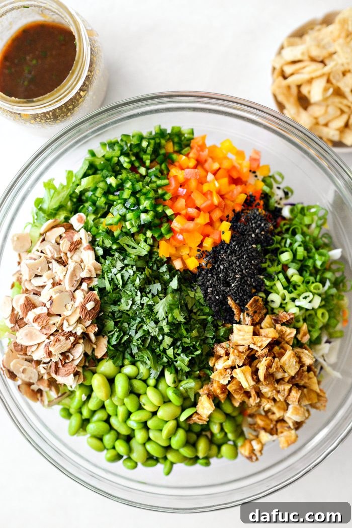 Tropical Teriyaki Salad 8 Adding all the colorful salad ingredients to the bowl