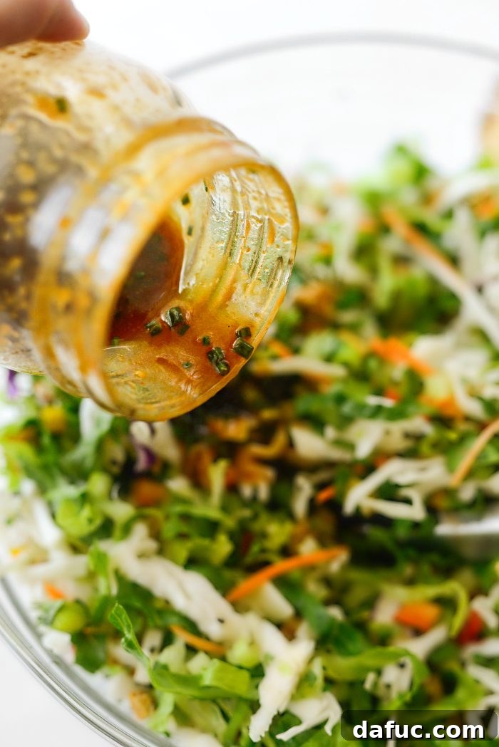 Tropical Teriyaki Salad 10 Pouring teriyaki dressing over the salad