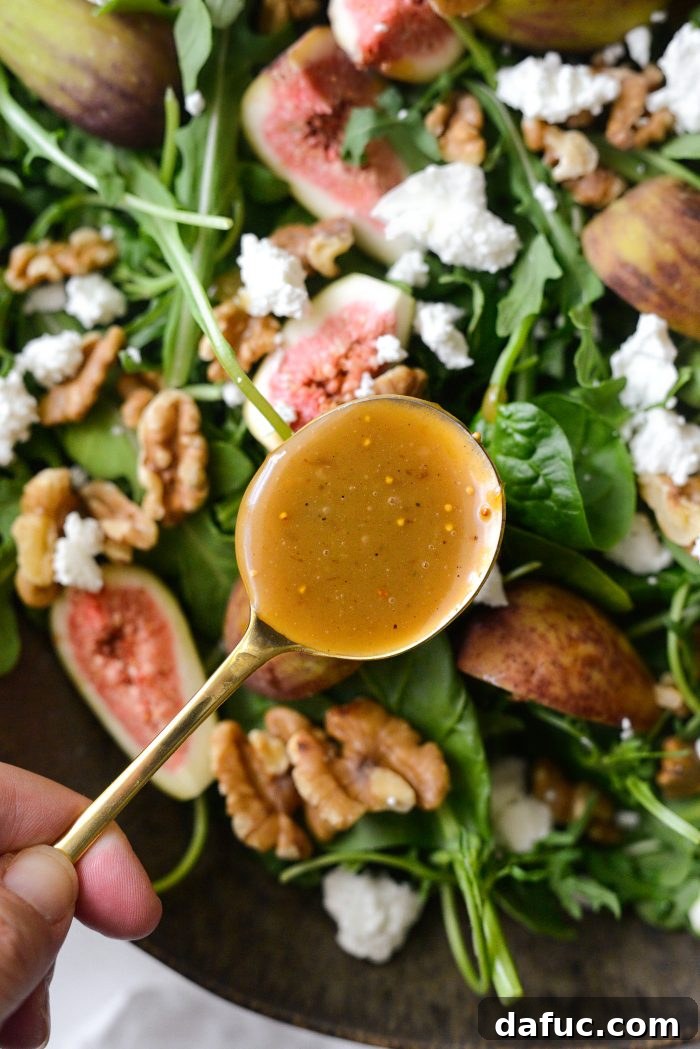 Drizzling fig balsamic vinaigrette over the salad