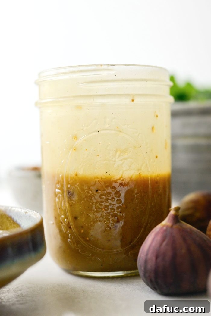 Shaking fig and balsamic vinaigrette in a jar to emulsify