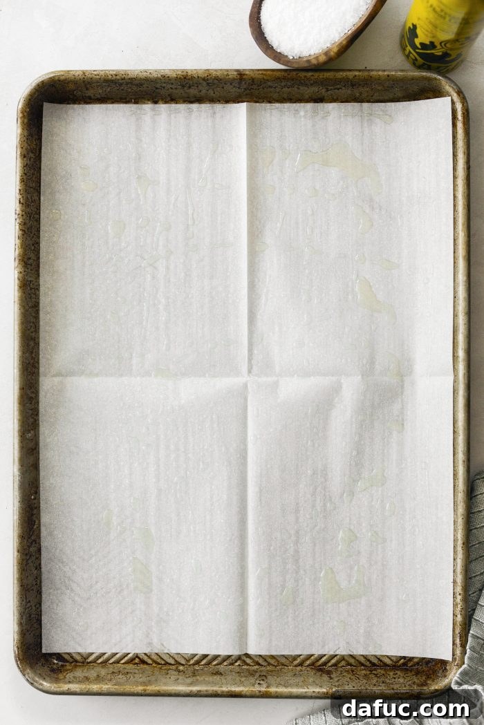 Golden Crispy Homemade Croutons 4 Baking sheet lined with parchment paper, lightly sprayed with olive oil, ready for bread cubes