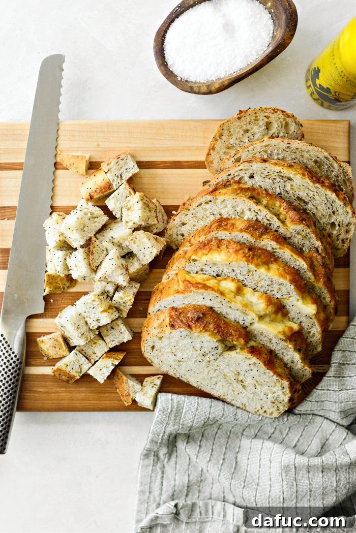 Golden Crispy Homemade Croutons 5 Hands carefully slicing a loaf of bread into even pieces and then cubing them on a cutting board