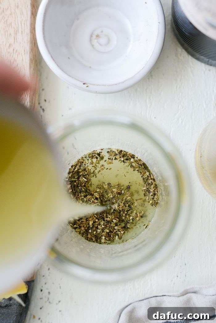 Pouring strained lemon juice into the jar with dry ingredients