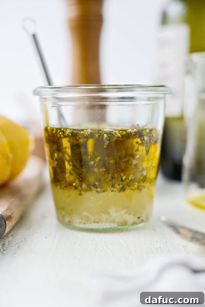 Ingredients in a jar before whisking, showing separation of oil and water