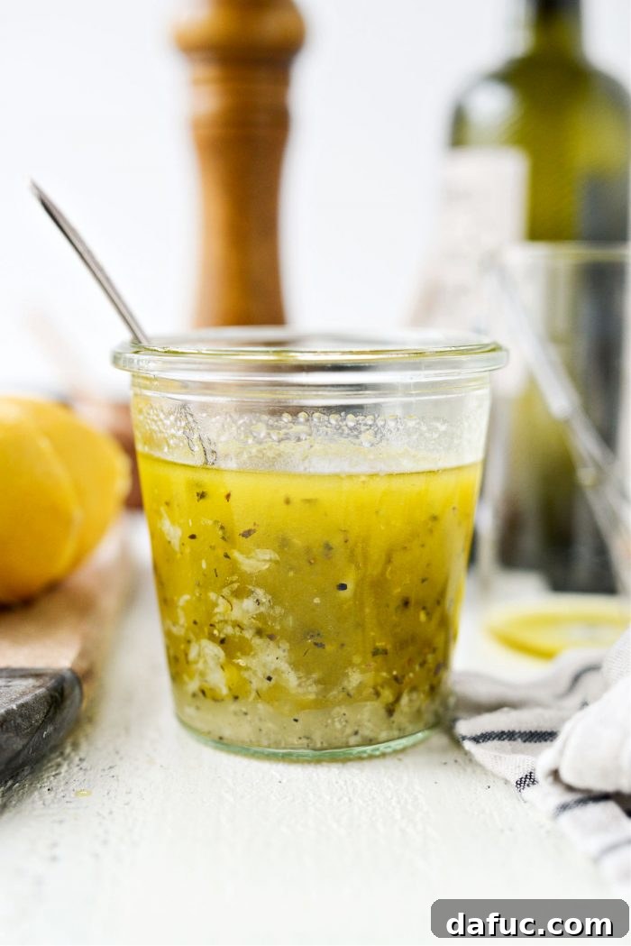 Homemade Greek Dressing poured over a fresh salad, illustrating its versatility