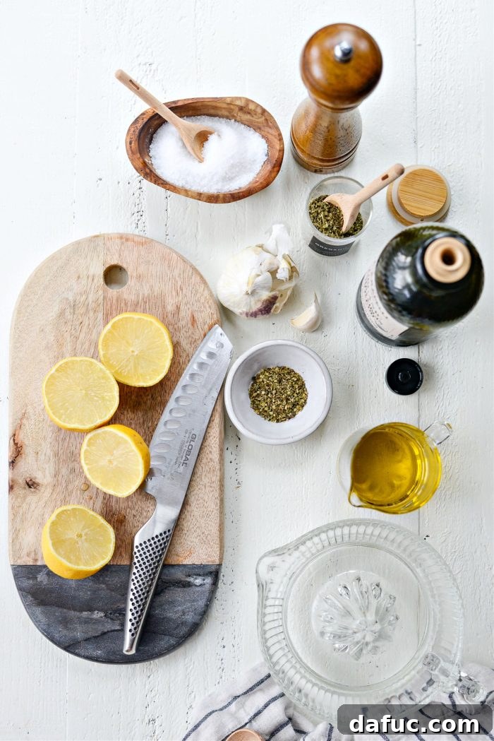 Close-up of fresh ingredients for homemade Greek dressing: garlic, lemon, oregano, olive oil