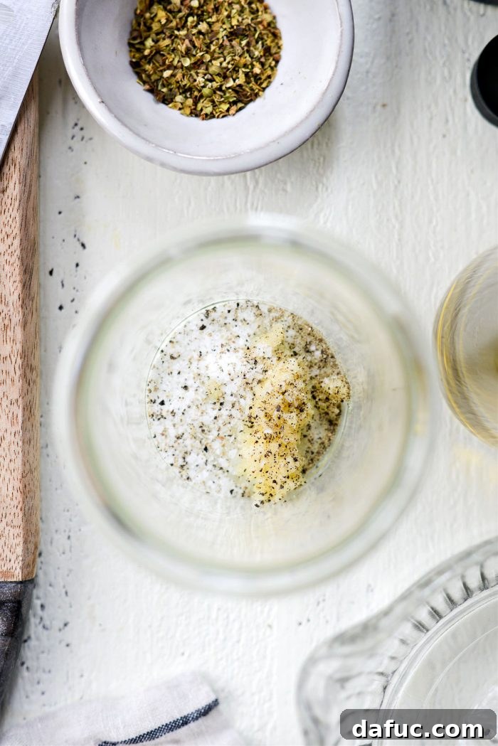 Garlic cloves, kosher salt, and black peppercorns, key ingredients for Greek dressing