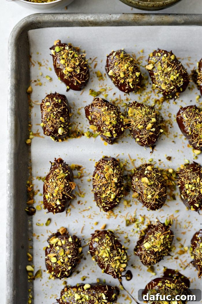 Dubai Stuffed Dates being sprinkled with chopped pistachios and crushed kataifi