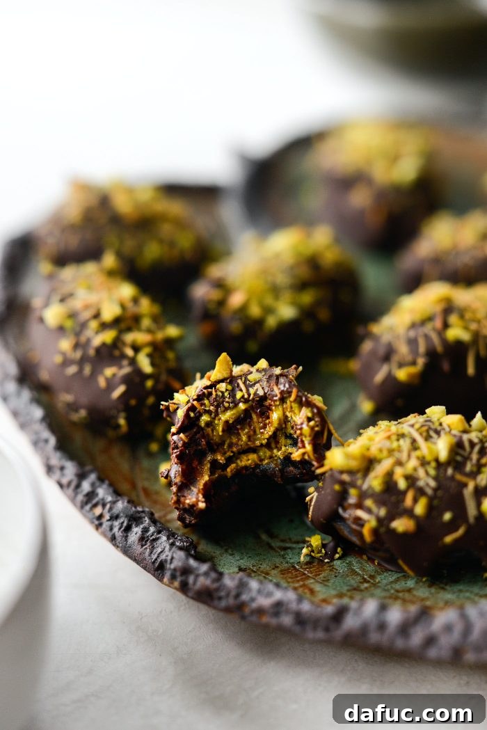 Close-up of Dubai Stuffed Dates showcasing rich chocolate and pistachio filling