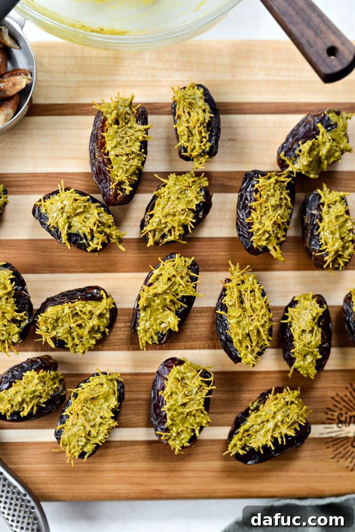 Dates being carefully filled with pistachio and kataifi mixture