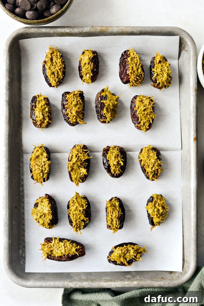 Filled dates being refrigerated on a baking sheet
