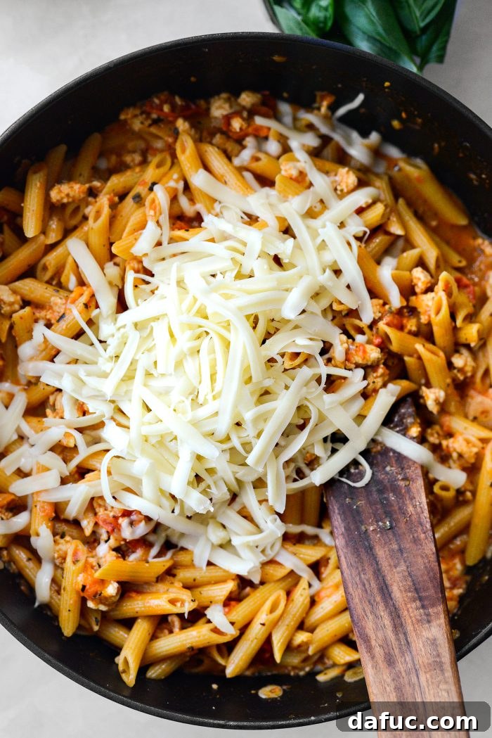 Mozzarella cheese added to the hot pasta