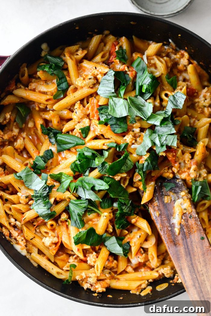 Torn fresh basil added to the pasta