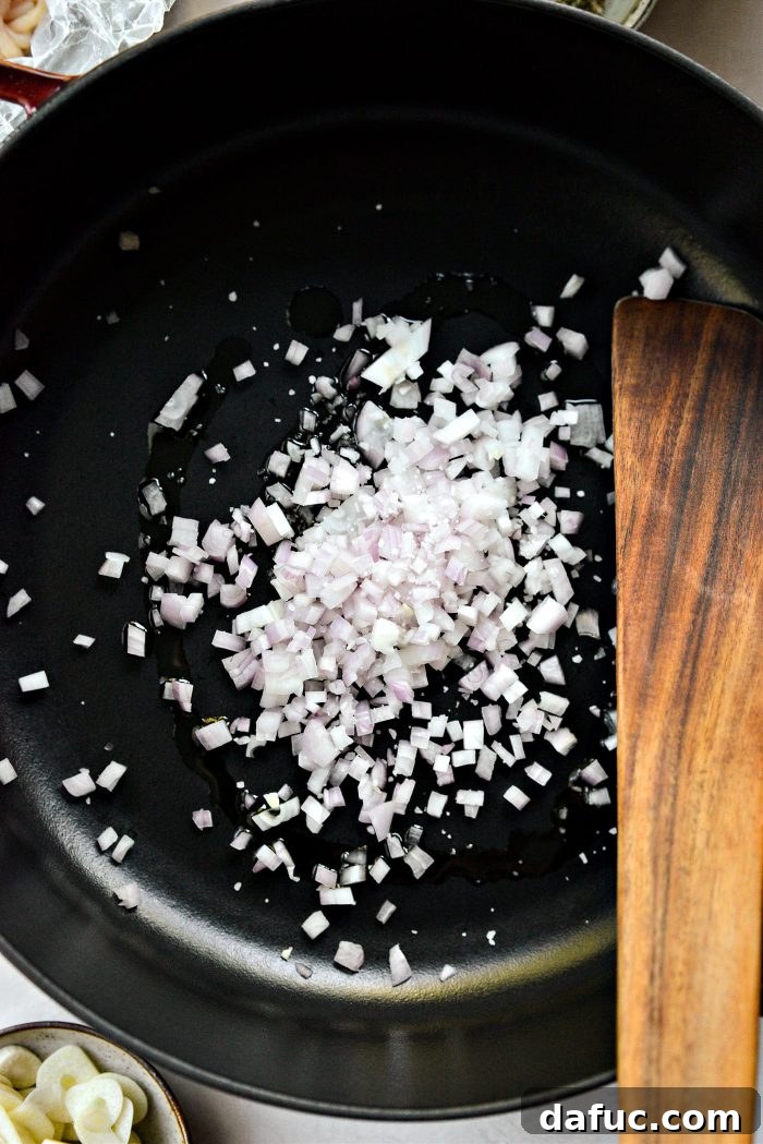 Olive oil, shallots, and salt sizzling in a pan