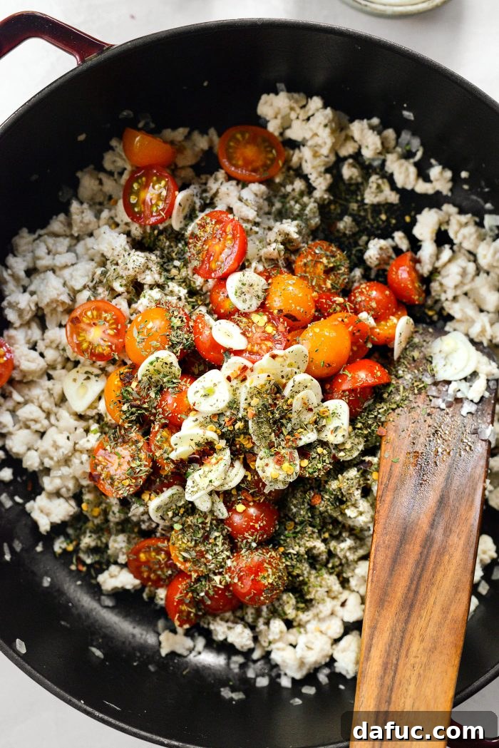 Tomatoes, garlic, Italian seasoning, salt, and red pepper flakes added to cooked chicken
