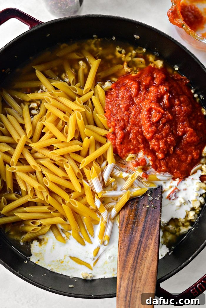 Penne, broth, marinara, and heavy cream added to the skillet