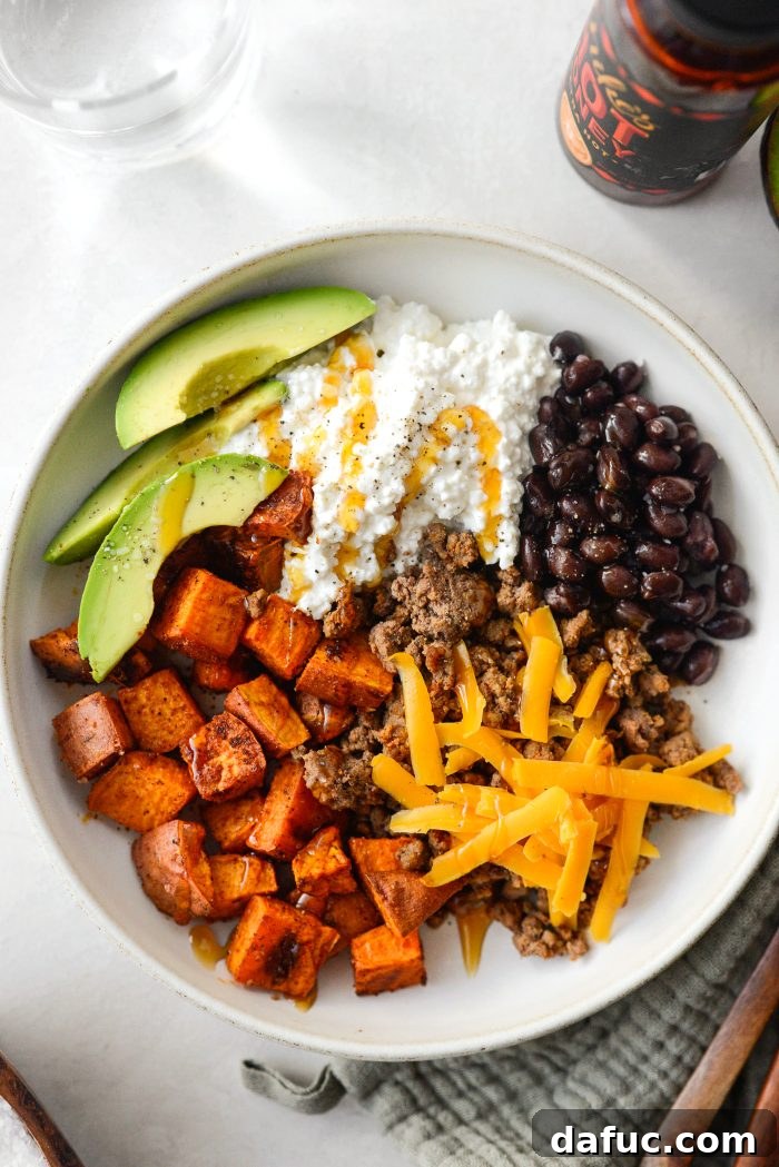 A fully assembled Sweet Potato Beef Bowl with Hot Honey, ready to be served.