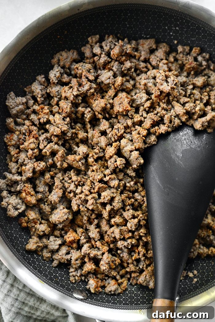 Seasoned ground beef mixture in a skillet, thoroughly combined.