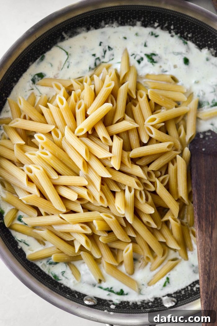 once spinach has wilted add in grated nutmeg