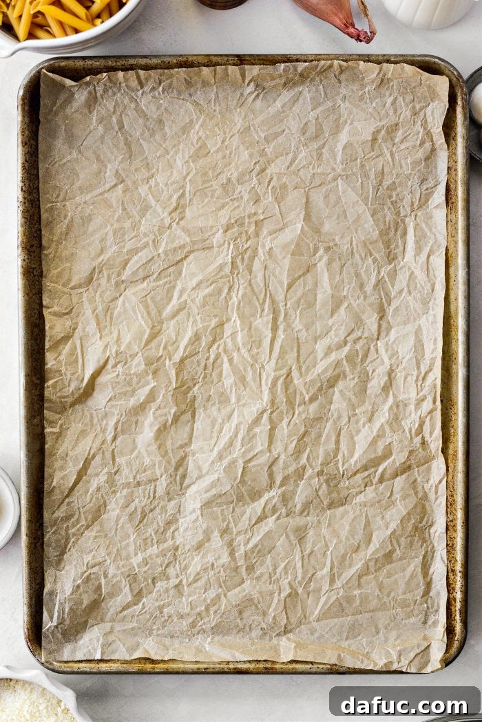 preheat oven and line a rimmed baking sheet with parchment 