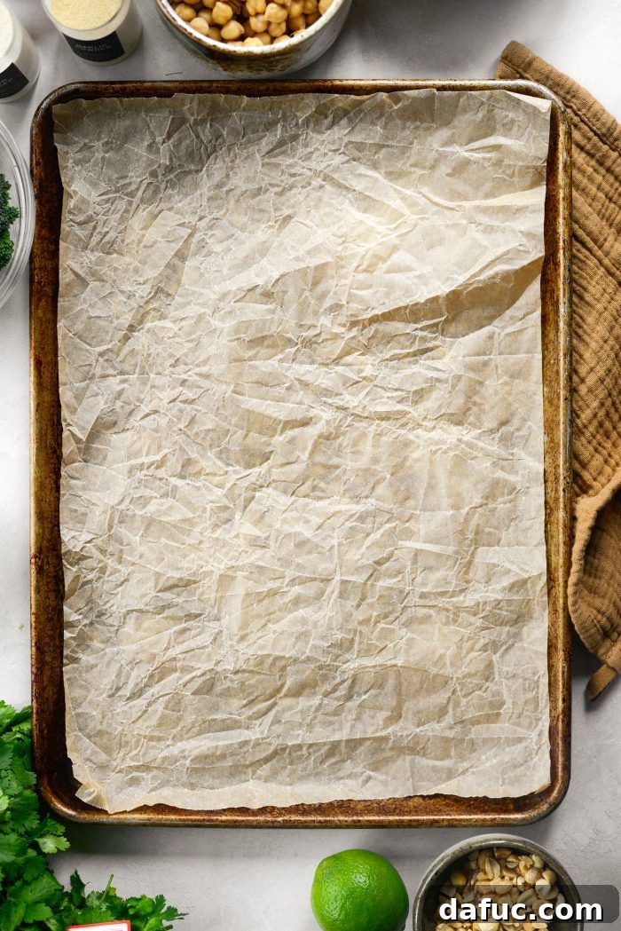 Preheating oven and lining baking sheet with parchment paper
