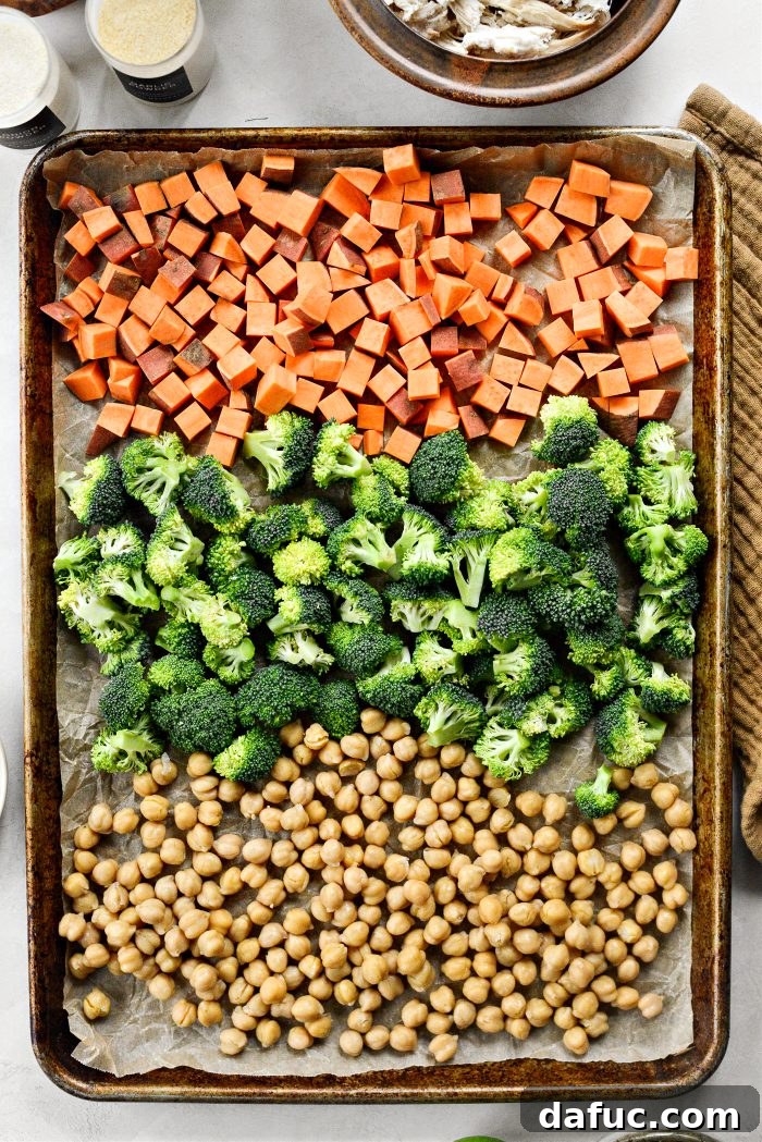 Adding vegetables and chickpeas to a prepared baking pan