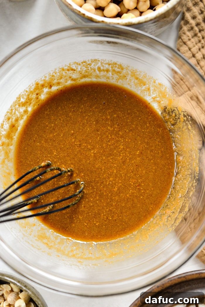 Whisking peanut sauce ingredients to combine