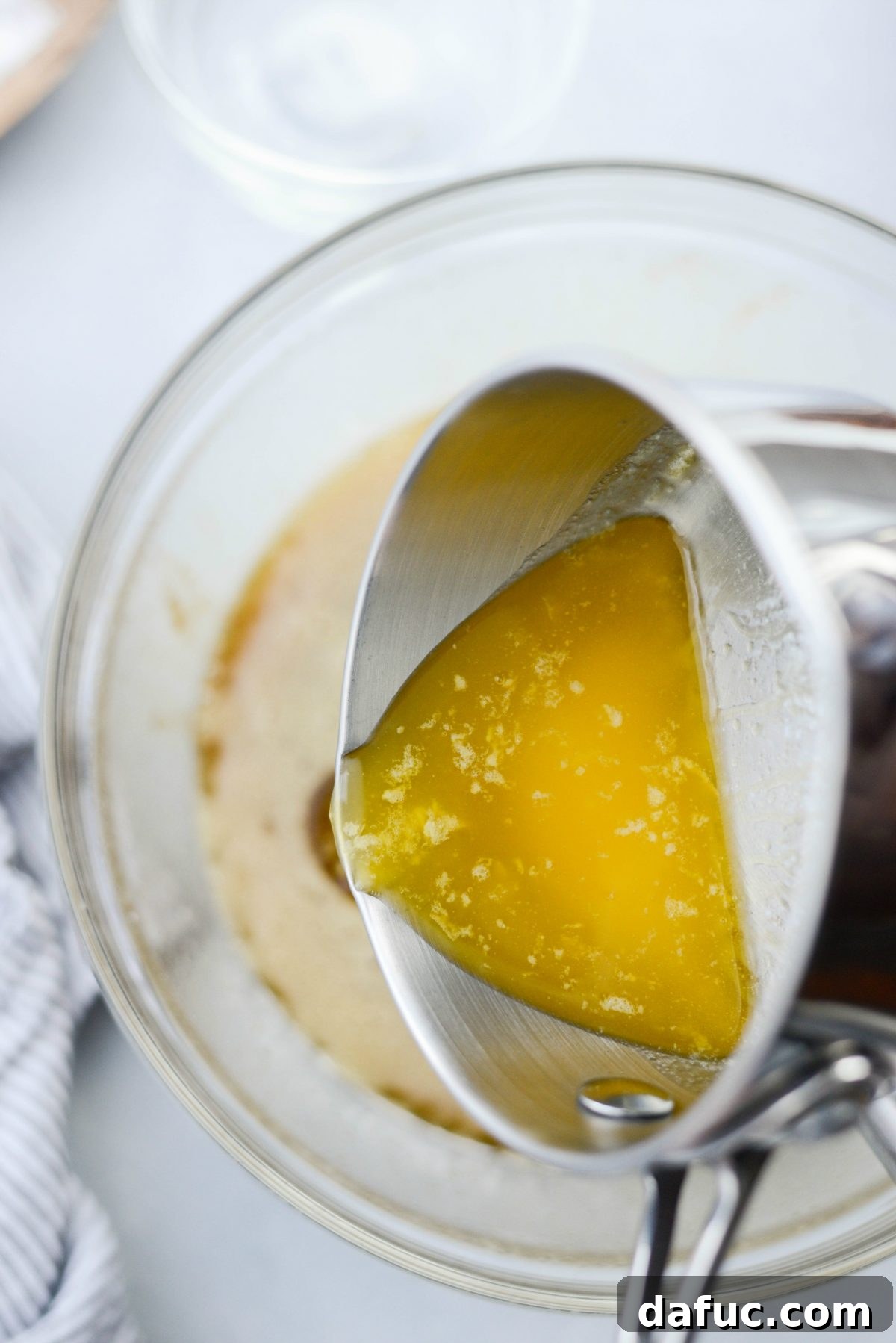 Irresistible Classic Pecan Pie 11 Pouring in melted and cooled butter.