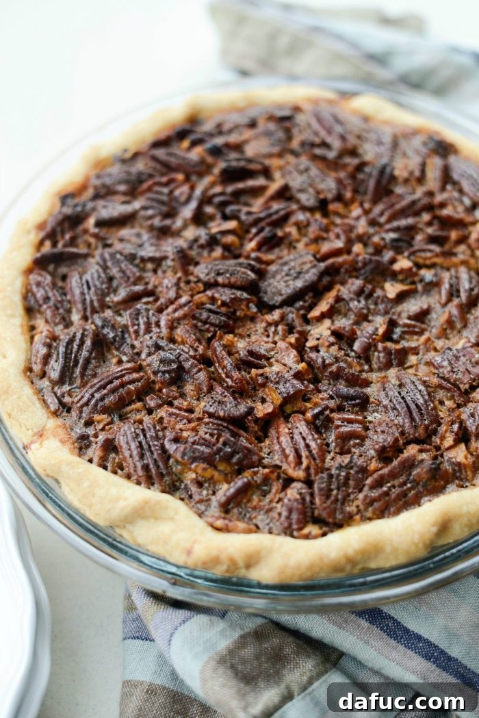 Irresistible Classic Pecan Pie 19 Delicious Pecan Pie slice ready to be enjoyed with a drink.