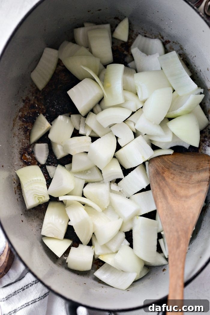 Guinness-Infused Irish Beef Stew 15 Adding chopped onions to the Dutch oven