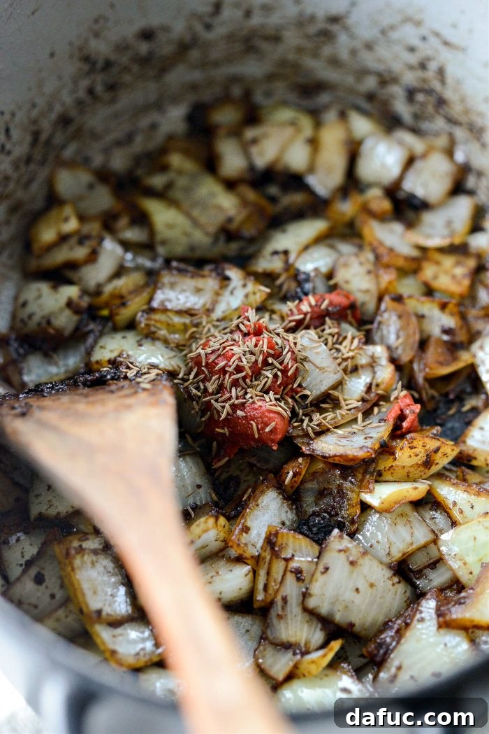 Guinness-Infused Irish Beef Stew 17 Tomato paste and caraway seeds added to onions