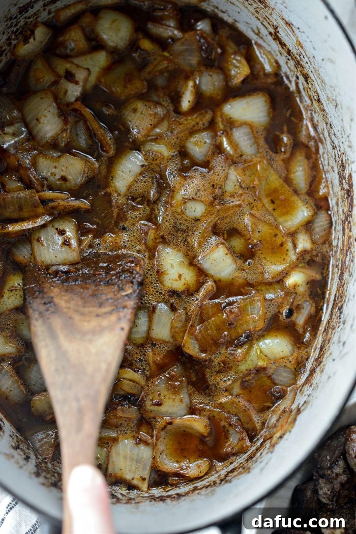 Guinness-Infused Irish Beef Stew 20 Scraping the bottom of the pan with a wooden spatula to release fond